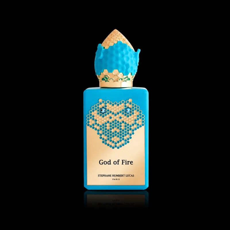 Blue perfume bottle with intricate gold crown and honeycomb design featuring the name 'God of Fire'